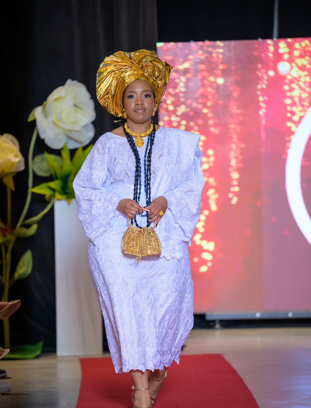 Adeyemi Royalabel runway look, an elegant white lace ensemble with a sculptural gold gele and layered jewelry