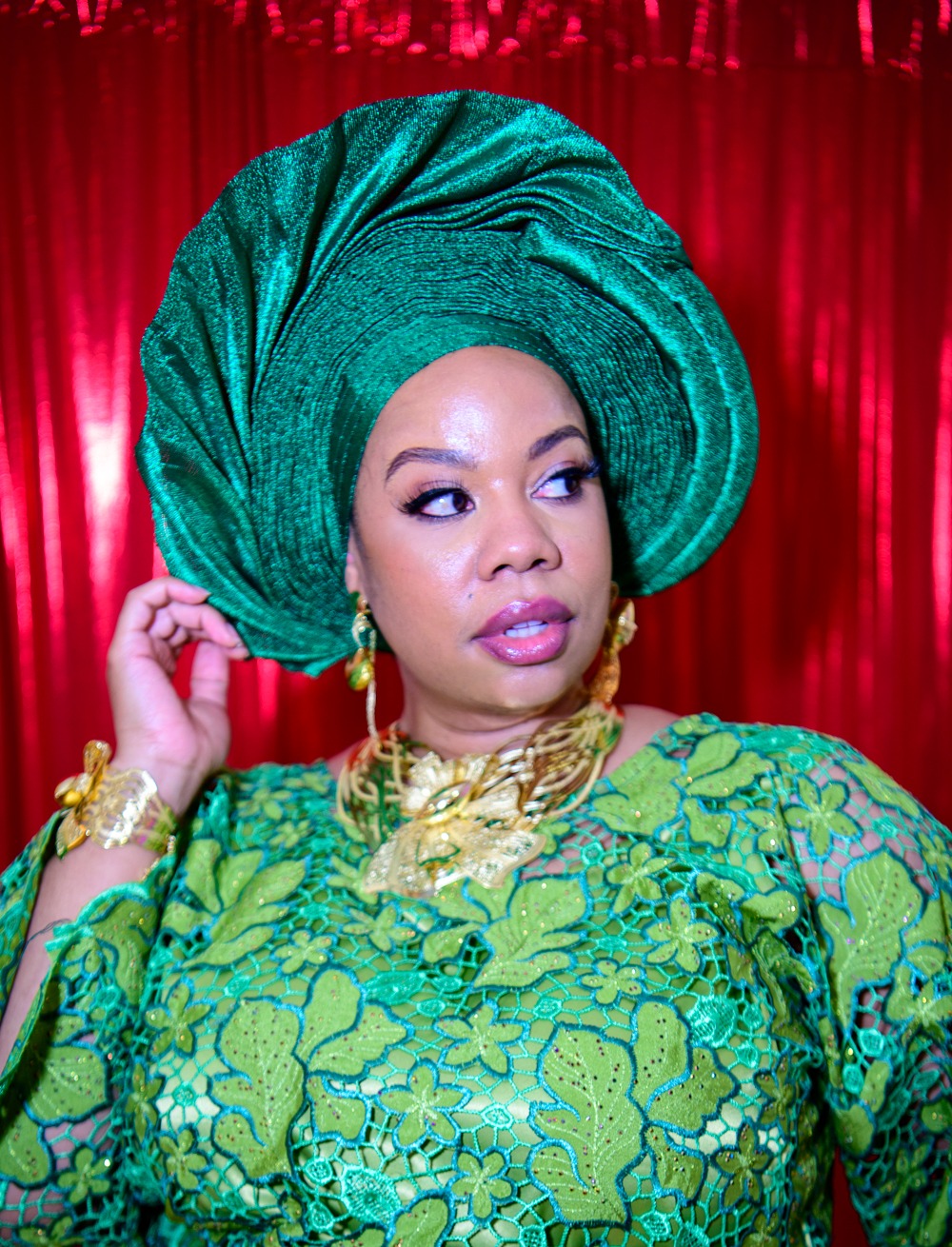 Close detail of green lace craftsmanship with emerald gele and gold jewellery by Adeyemi RoyaLabel