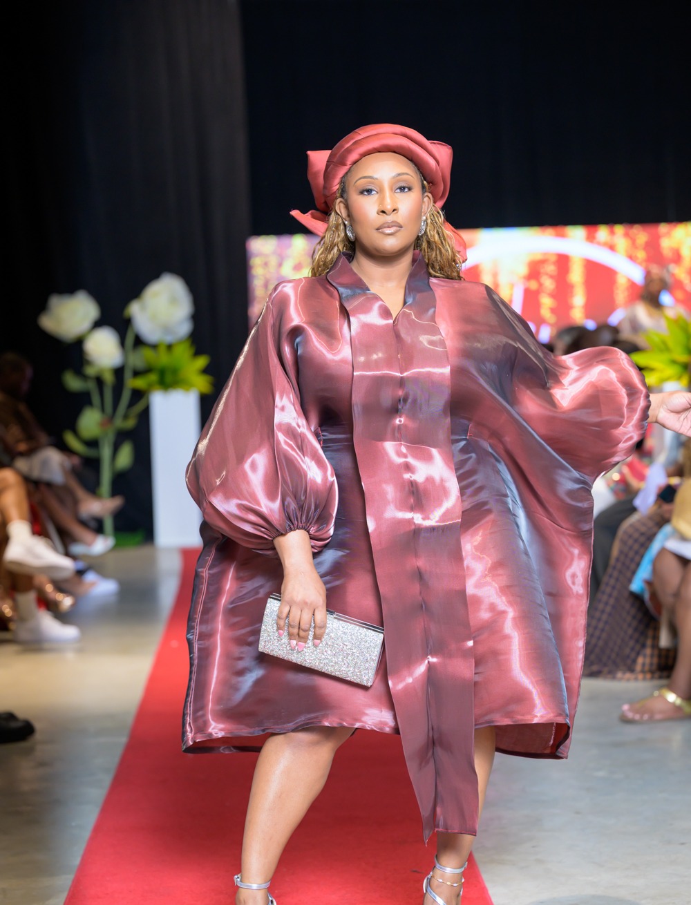 Adeyemi Royalabel womenswear look, a sculptural burgundy metallic ensemble with dramatic sleeves and a matching headpiece